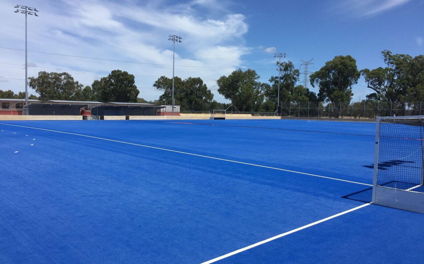 View of a Porter project, a blue hockey turf at Guildford Grammar